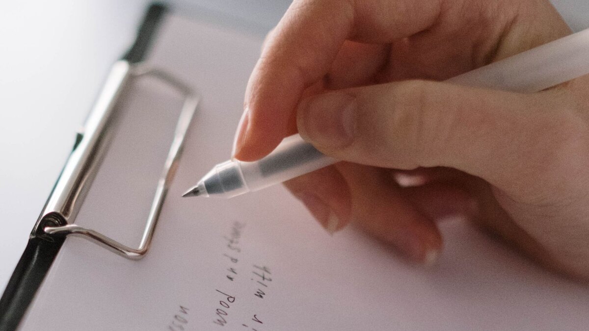 Office notepad with a street address being written by hand, the current reorder process